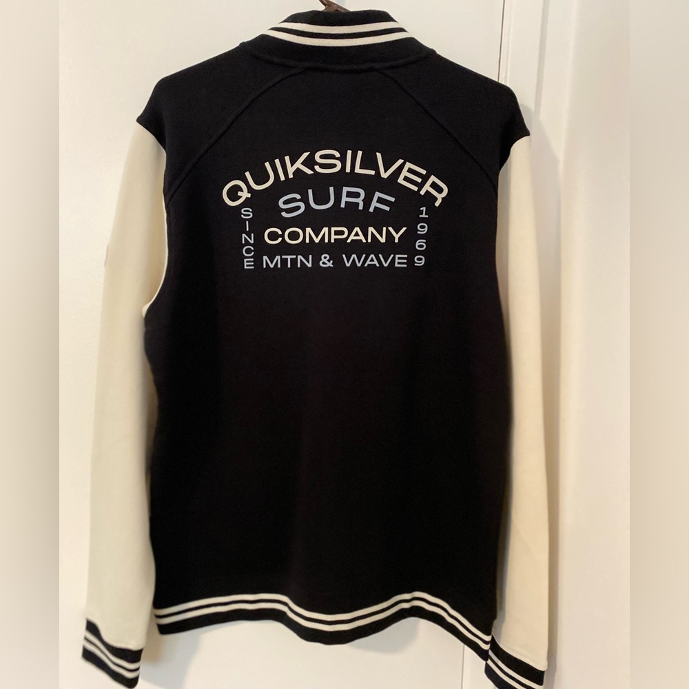 Quiksilver zip up sweater. Black with off white sleeves. NEW with tags